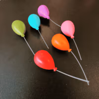 Koelkastmagneetjes Ballon in kleuren rood, oranje, roze, groen, aqua blauw en paars op een zwarte achtergrond