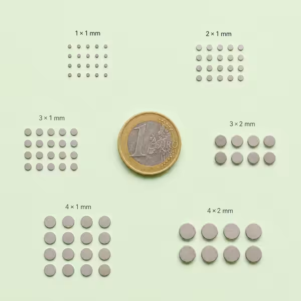 Testset kleine neodymium magneten voor modelbouw met 1x1 mm tot 4x2 mm magneten naast een euro munt als maatreferentie